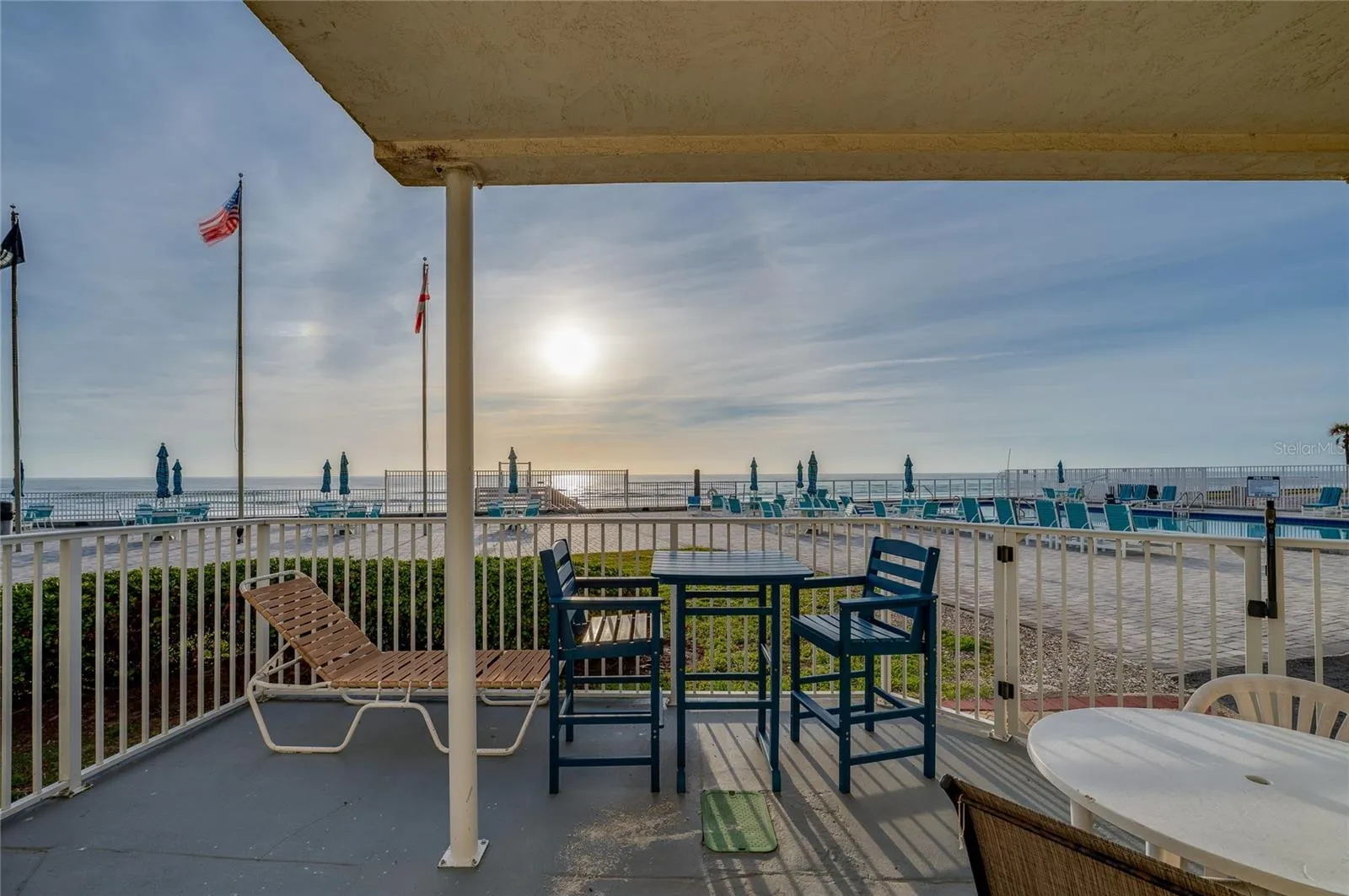 Private ground-floor patio offering stunning, unobstructed views of the Atlantic Ocean and the community pool.