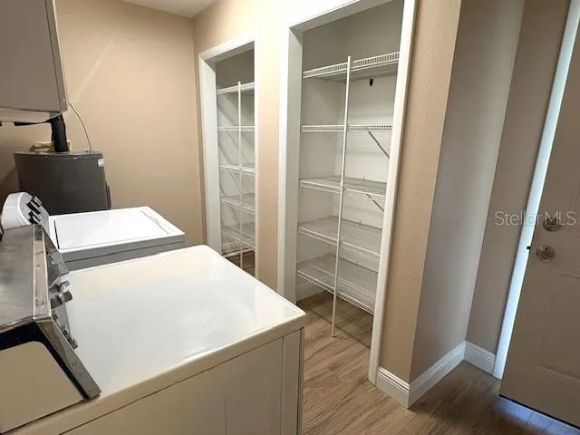 Indoor laundry room and pantry, situated between the kitchen and garage doorways.