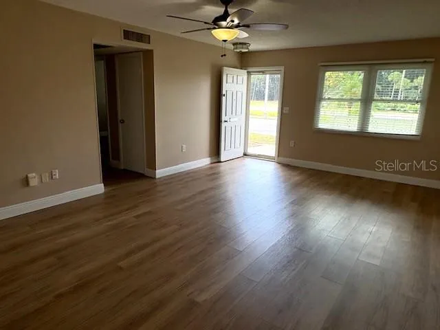 Living room, facing front entry, and hallway to bedrooms.