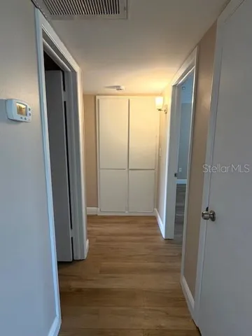 At the end of the hallway is a traditional built-in linen closet.