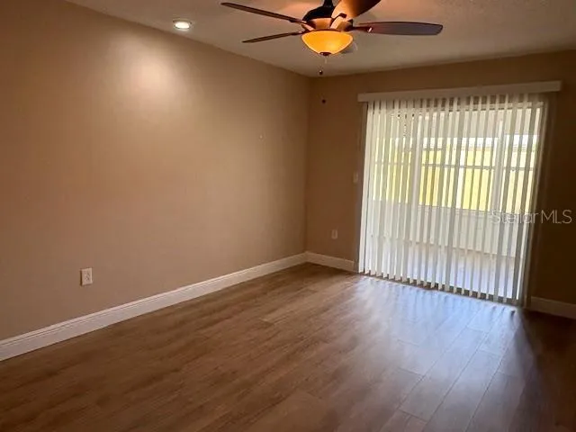 Primary bedroom features sliding glass doors that lead to the bonus room.