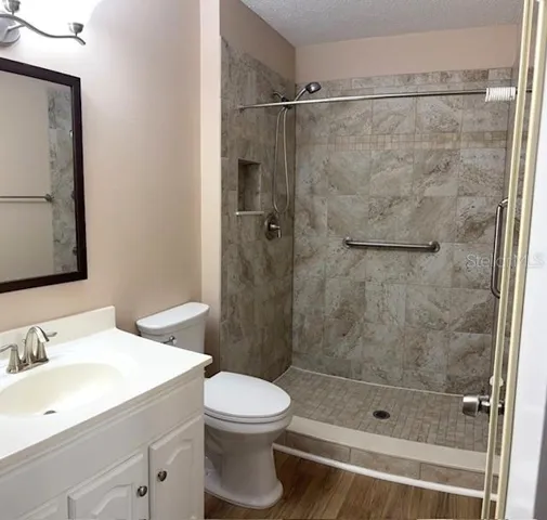 Beautifully updated bathroom with a tile step in shower.
