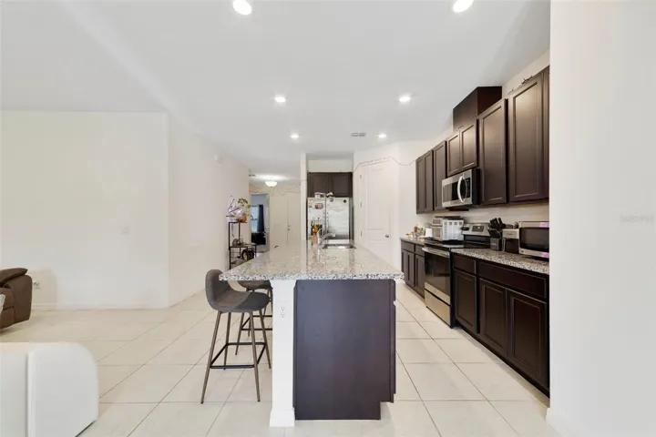 At the heart of the home, the beautiful Kitchen combines style and functionality with 42-inch cabinetry, GRANITE COUNTERTOPS, stainless steel appliances, a closet pantry, and a large center island with breakfast bar seating.