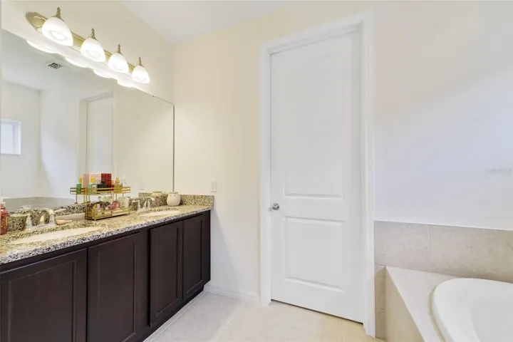 The Primary EN SUITE BATH features dual sinks, a relaxing garden tub, and a separate step-in shower.