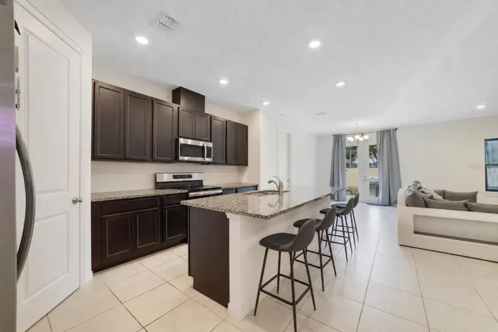 At the heart of the home, the beautiful Kitchen combines style and functionality with 42-inch cabinetry, GRANITE COUNTERTOPS, stainless steel appliances, a closet pantry, and a large center island with breakfast bar seating.