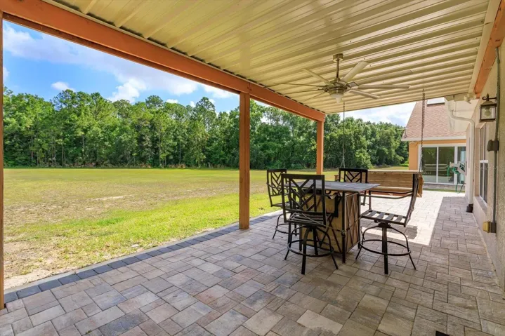 Covered porch has gorgeous pavers and is accessed by the Primary Suite