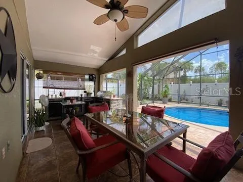 Covered porch has seating area and an outdoor kitchen