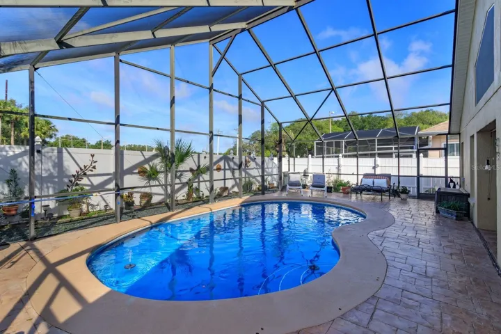 Lanai has vaulted screening which follows the roof of the house