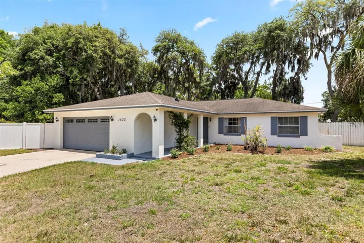 Front of home.  Large driveway and yard