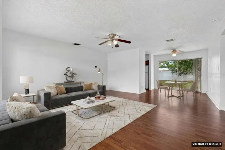 Virtually staged. Open living and dining space with easy access to the fenced backyard through sliding doors