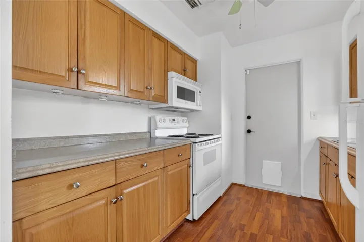 Kitchen with stove and built-in microwave