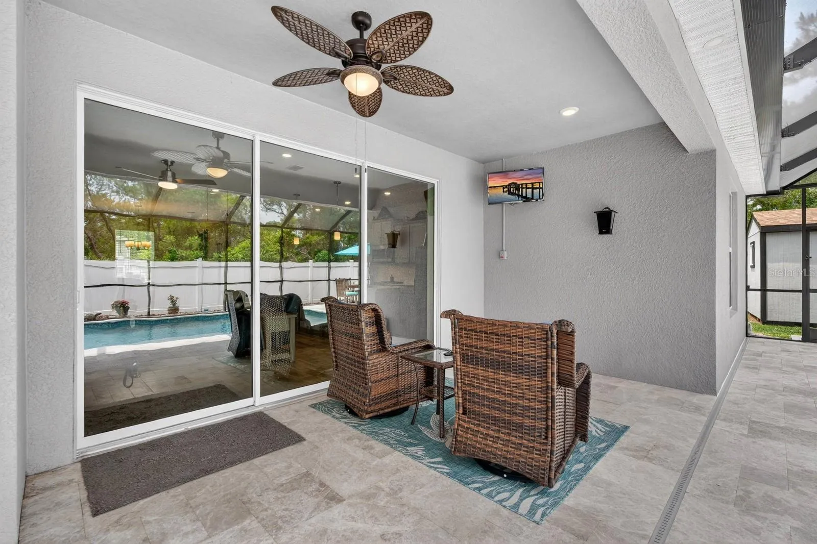 covered lanai area with TV