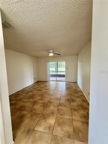 Large master bedroom with sliding glass doors to closed in patio
