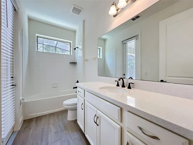 First level full bathroom with access to lanai and pool area