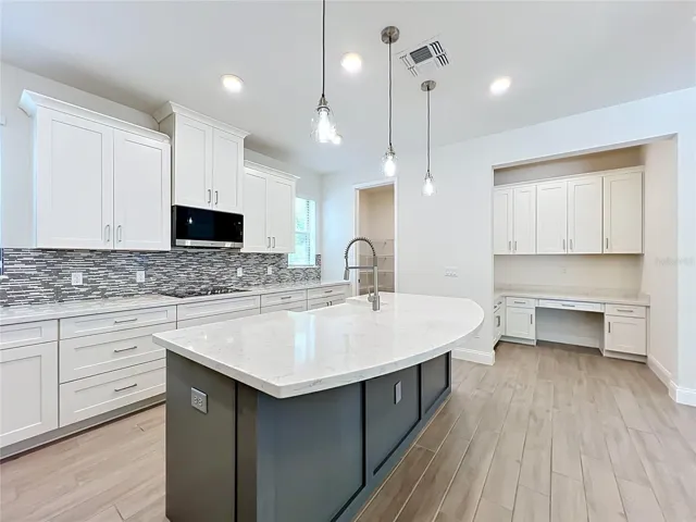 Gourmet kitchen featuring crown molding cabinetry,