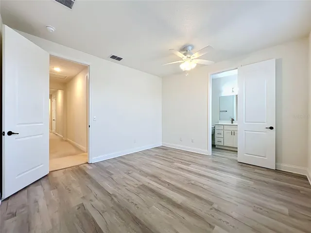 Private junior suite featuring luxury laminate flooring and an in-suite full bathroom.