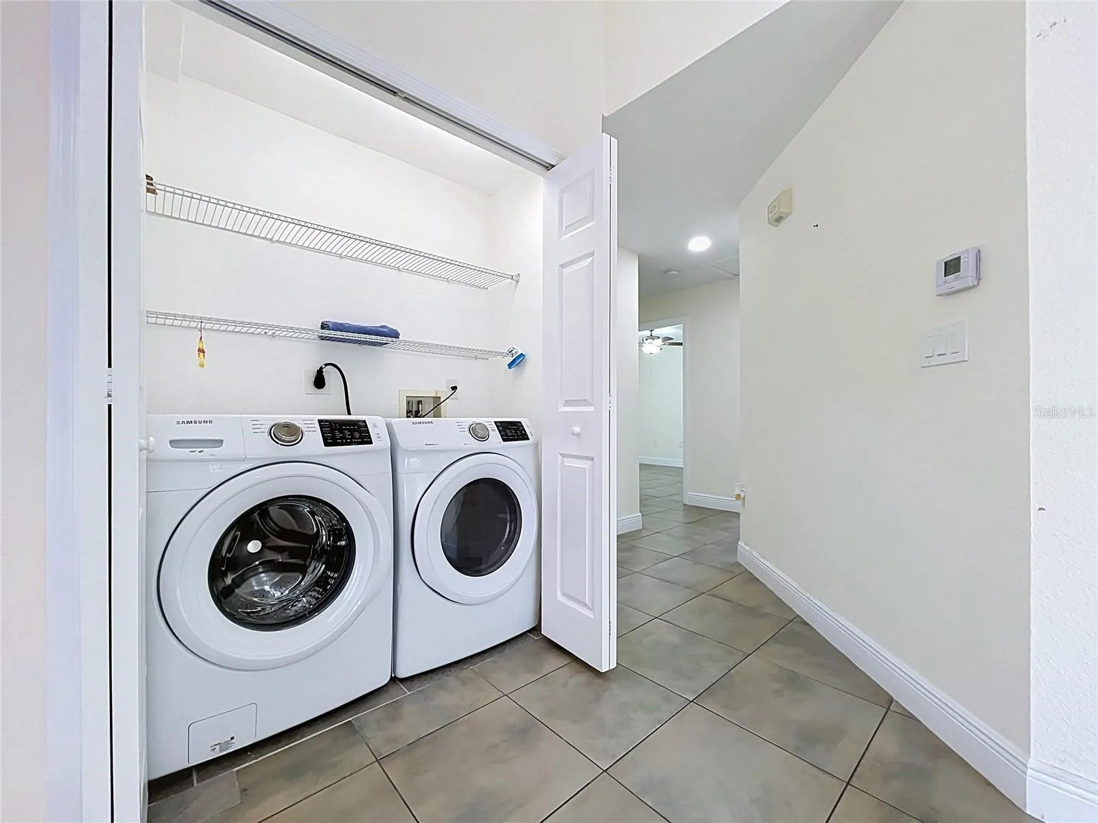 Laundry with Delux Appliances and Double Doors Enclosure