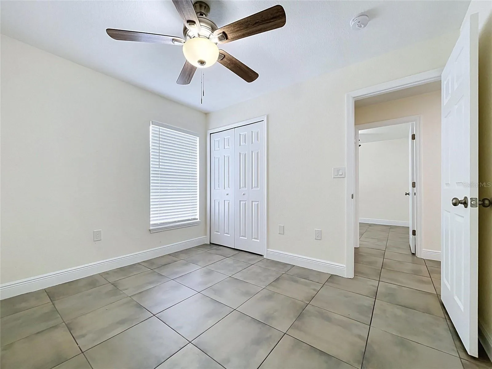 Bedroom with Fan,Ceramic Floor and Oversized Window and Closet
