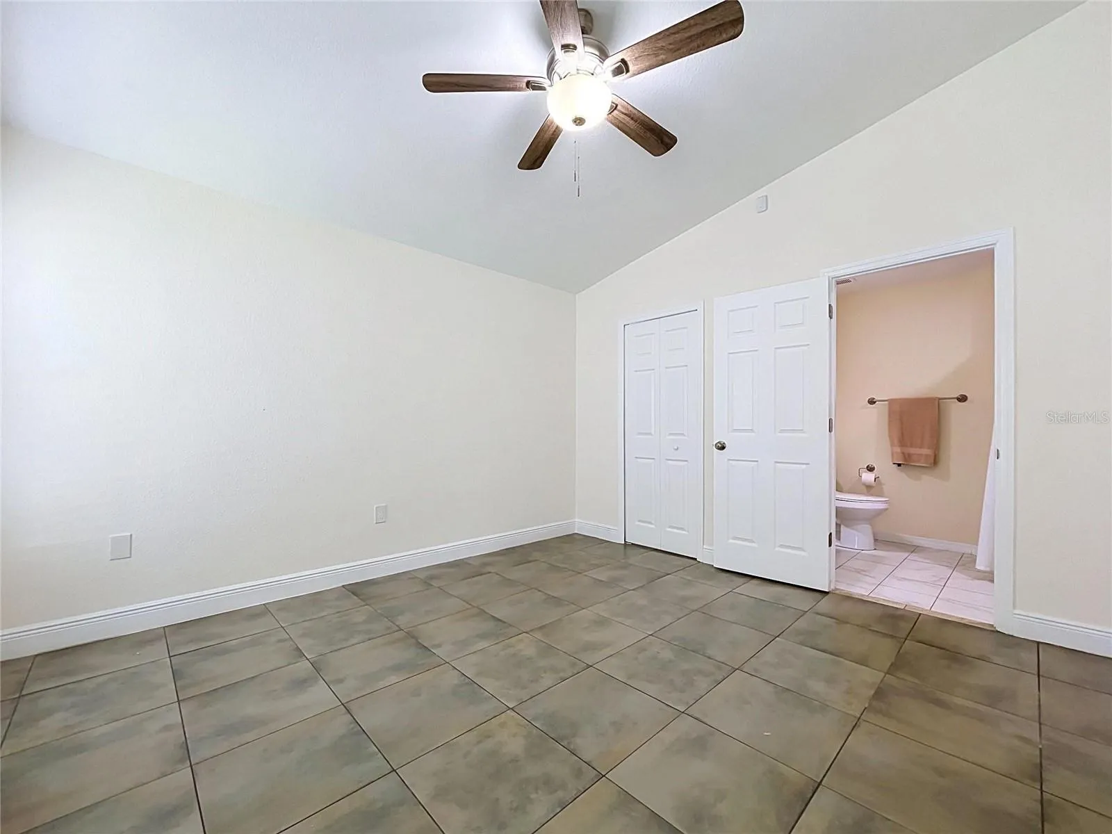 Master Bedroom with View of Bathroom and Walk-In Closet, Fan and Ceramic Floor