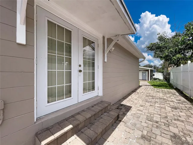 Main House Side View Shwoing Double Glass Doors to Exterior