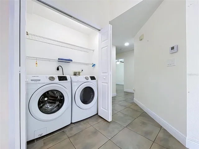 Laundry with Delux Appliances and Double Doors Enclosure