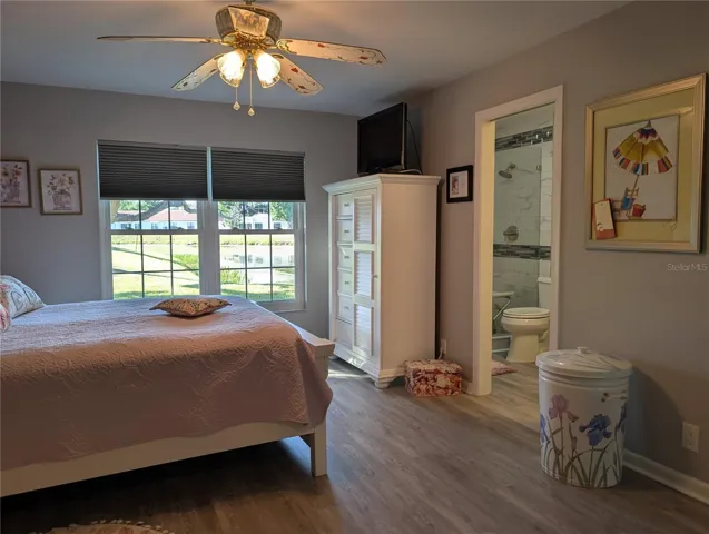 Spacious Master bedroom shares the spectular water view. Other features include ceiling fan w/light, newer luxury vinyl flooring (2023) and a private ensuite bath.