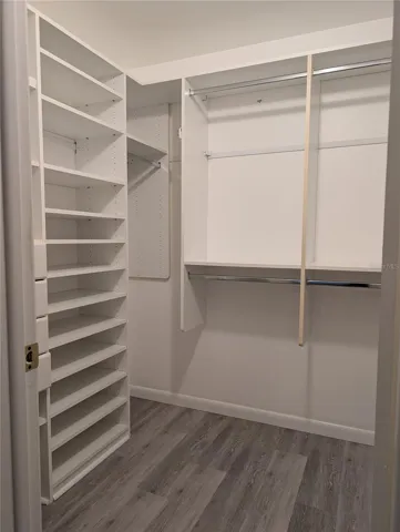 Master bedroom closet features California style organization with some special extras.