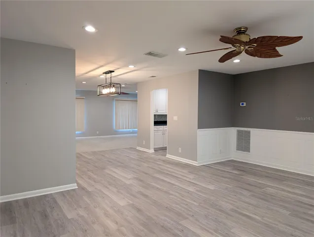 Open floor plan view of living room into dining room, kitchen and Florida room.