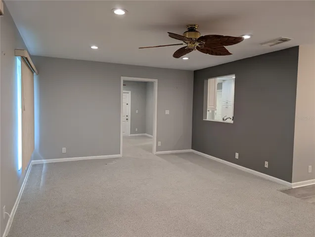View of Florida room into Bonus room and pass thru window to kitchen.