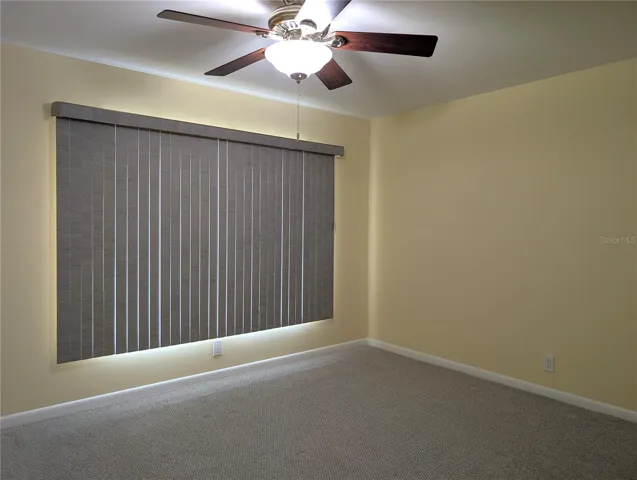 Spacious guest bedroom can comfortably accommodate a queen and king bed depending on the size of the dressers.