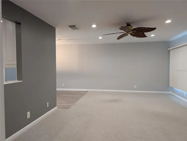 Family room with view of pass thru window to kitchen and dining room on left.