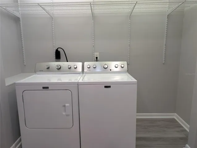 View of laundry area with storage.