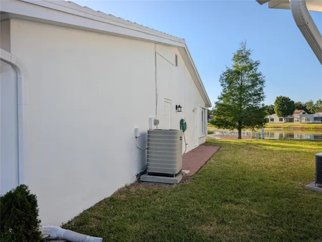 Exterior view of garage side of home to lake.