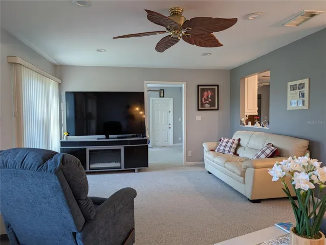 View of Florida room into Bonus room. Kitchen pass thru window to right.