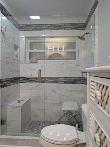 Gorgeous, tiled shower has window for more ventilation and light.