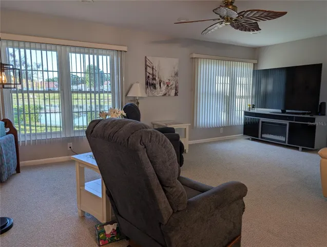 View from dining room into Florida room and the two large windows providing the natural light, natural air conditioning and the VIEW!