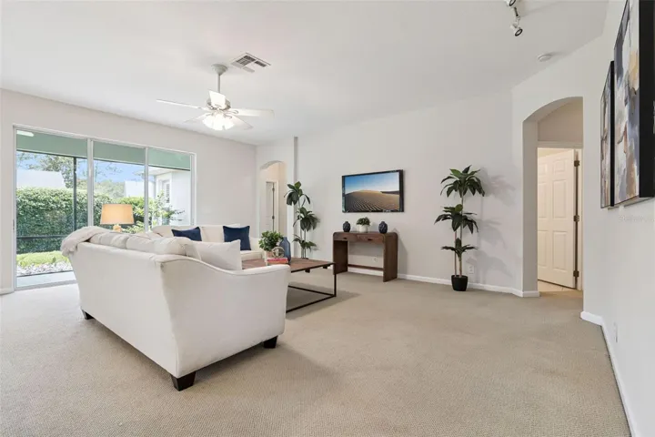17' x 21' Family Room w/ a ceiling fan & an electrical outlet in floor