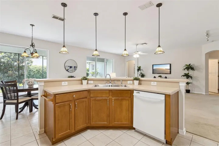 View of Family Room from Kitchen area w/ pendant lighting above breakfast bar