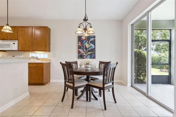 9' x 10' Dinette area w/ sliding glass door leading to screen enclosed covered patio
