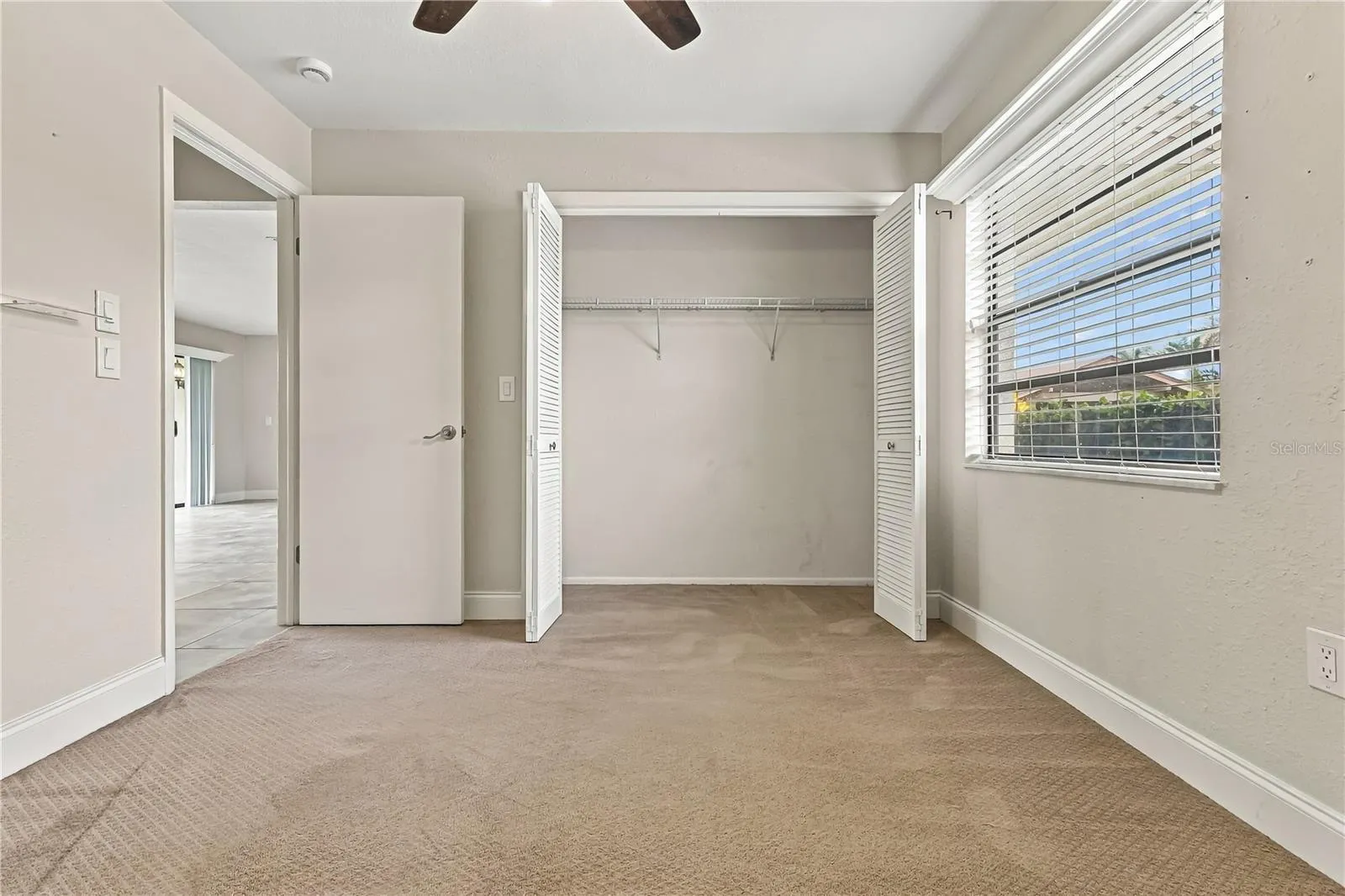 3rd room with doors leading to patio
