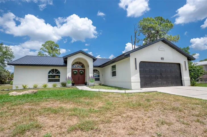 Front exterior of 3832 Wayward Ave, a professionally remodeled designer ranch in North Port, FL, situated on a 10,000 sq. ft. lot with No HOA.