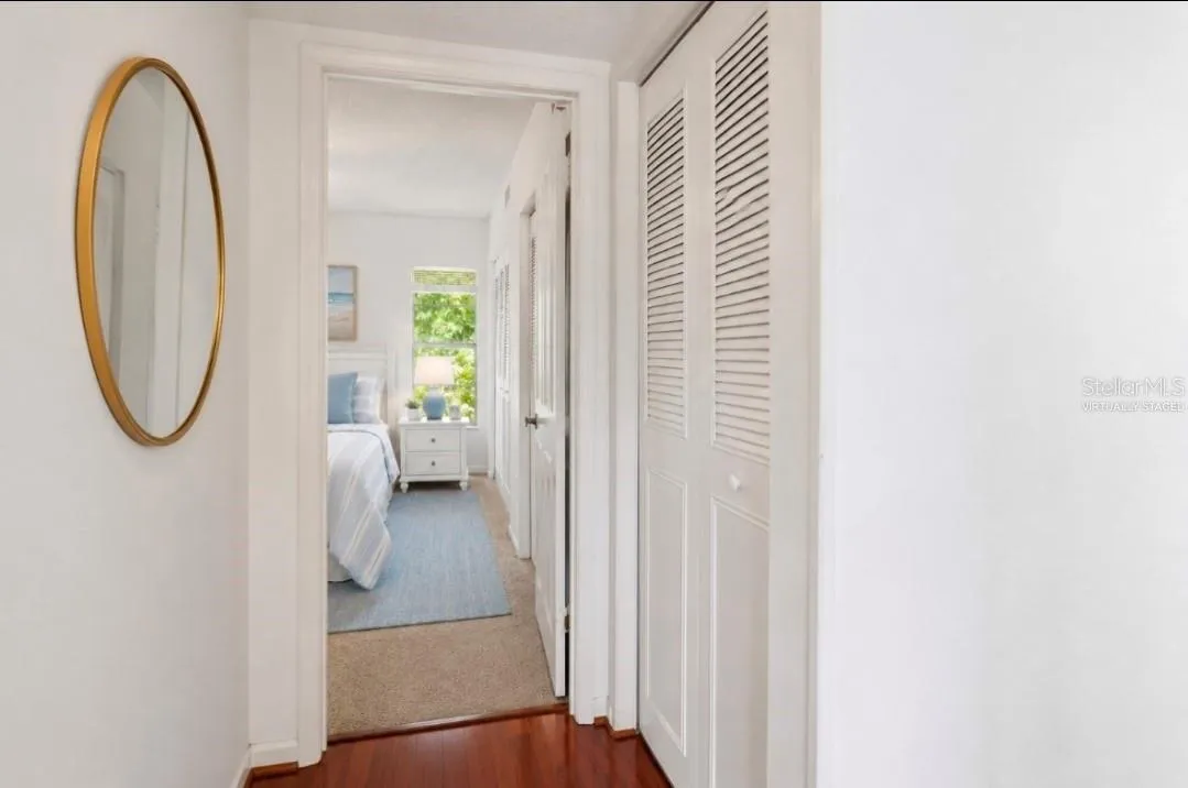 Hall way view to primary bedroom and linen closet(Partially virtually staged.