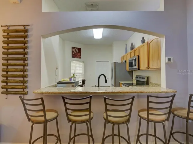 view to the Kitchen from the living room virtually staged