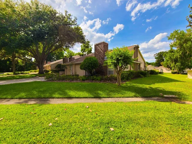Front side exterior view of townhouse in gated Woodland Village community. OM724494