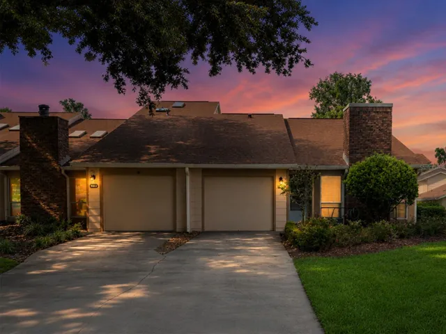 Evening twilight view highlighting exterior lighting and curb appeal. OM724494