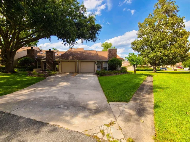 Front exterior view of 2321 SE 19th Cir in gated Woodland Village. OM724494