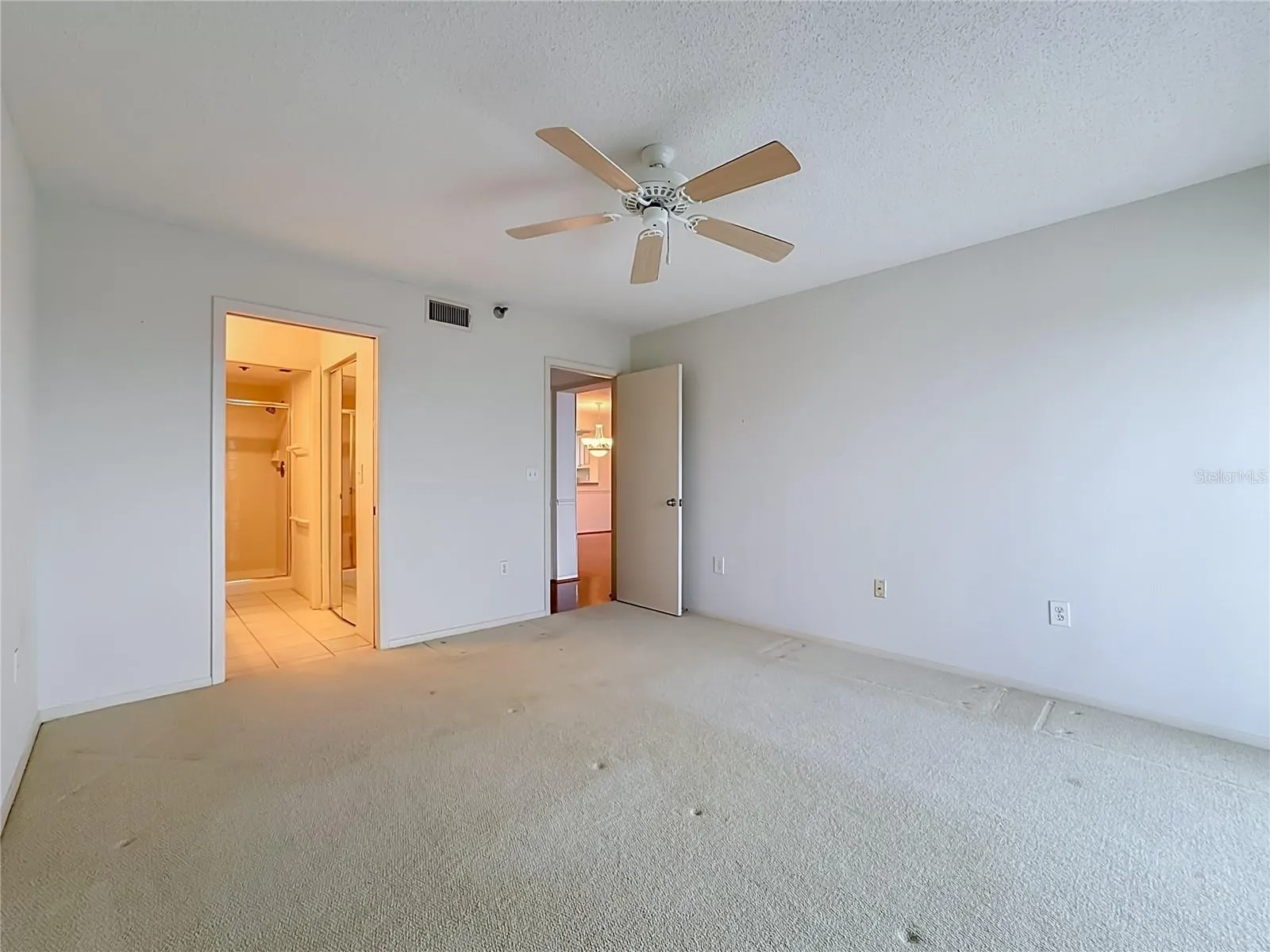 Primary bedroom with large walk-in closet and shower.