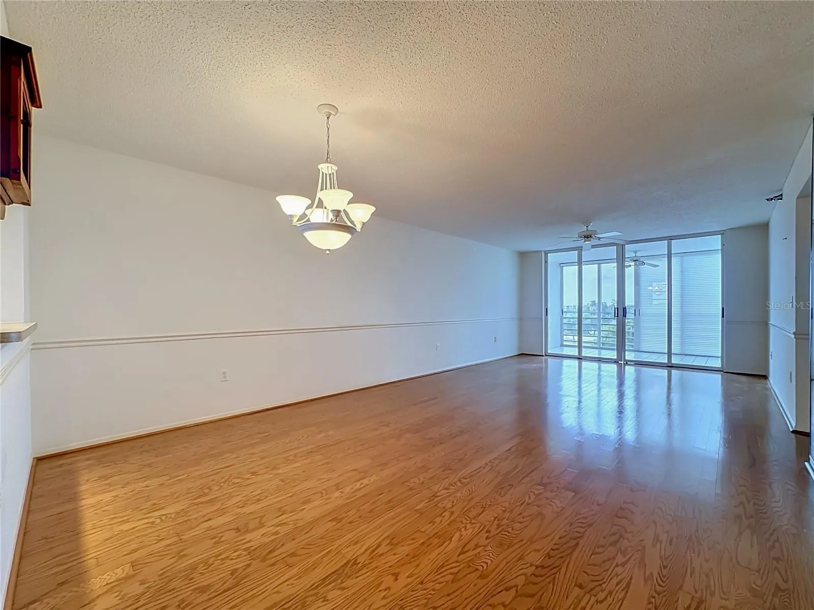 Full length view of the dining and living room combination.  Slidig door leads to the bigger of two enclosed lanais.