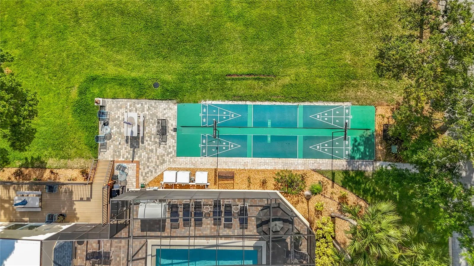 Shuffleboard and screen enclosed pool.