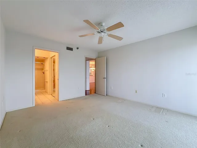 Primary bedroom with large walk-in closet and shower.